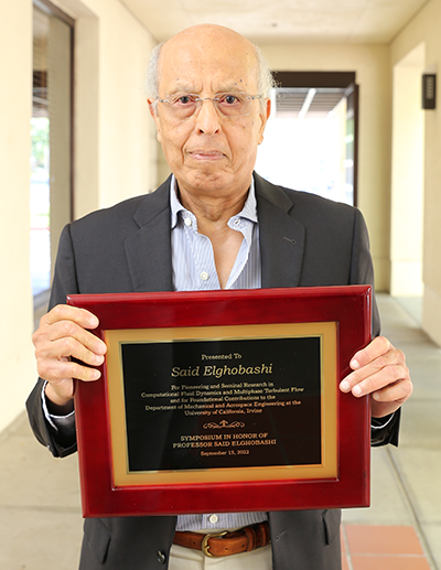 Said Elghobashi shows the plaque presented to him by Samueli School Dean Magnus Egerstedt in recognition of Elghobashi’s contributions to research and the university.