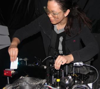 Michelle Digman angles a laser beam into a special microscope to excite the flourescent molecules in tissue