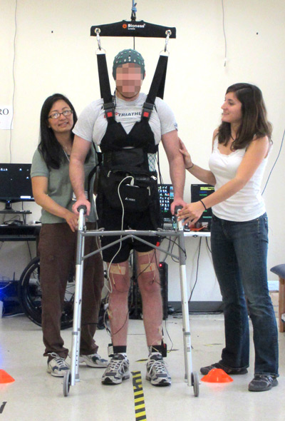 A man whose legs had been paralyzed for five years walks along a 12-foot course using UCI-developed technology that lets the brain bypass the spinal cord to send messages to the legs.