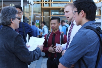 Engineering students talk with recruiter at EngiTech career fair